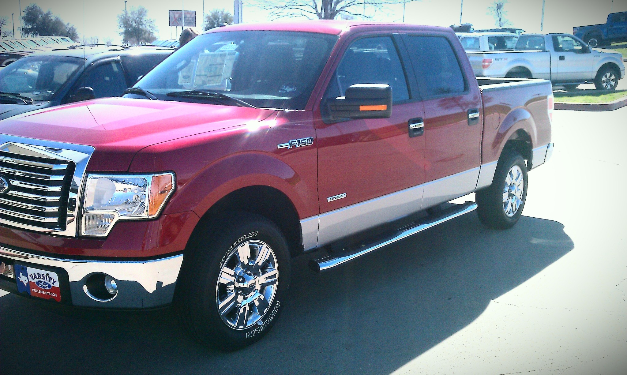 A red 2011 Ford F-250 truck with 'Texas edition' trim package.